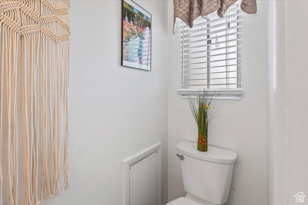 Bathroom with toilet and a chandelier