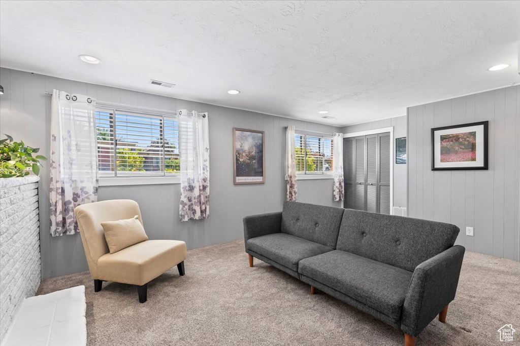 Carpeted living room featuring recessed lighting