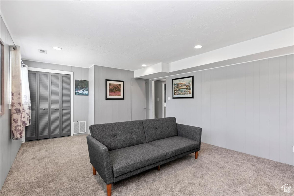 Living area with carpet and recessed lighting