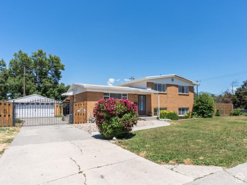 Split level home with brick siding and concrete driveway