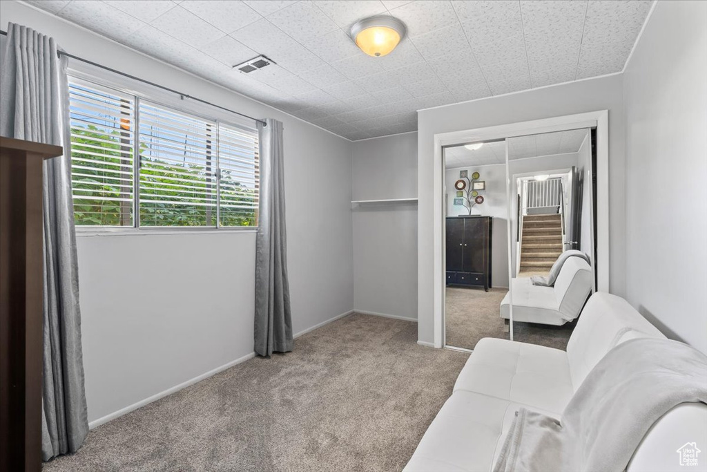 Carpeted bedroom featuring a closet and baseboards