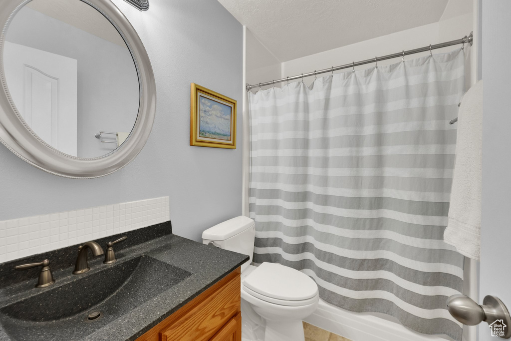 Full bath featuring vanity and curtained shower