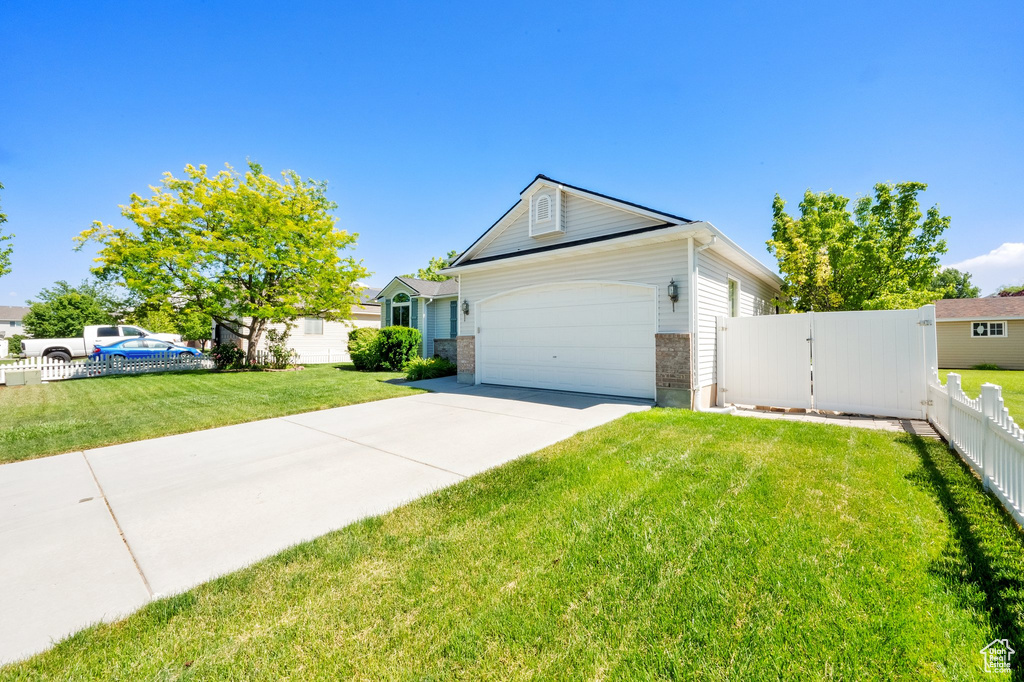 View of front of home featuring driveway, a garage, and brick siding