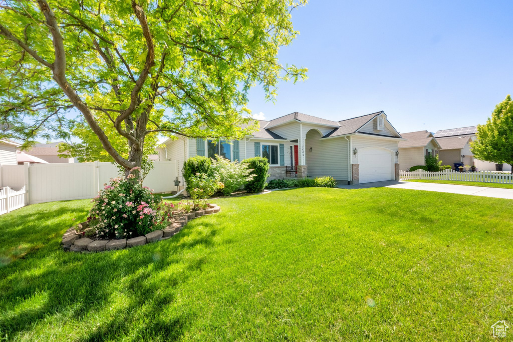 View of front of house with driveway and an attached garage