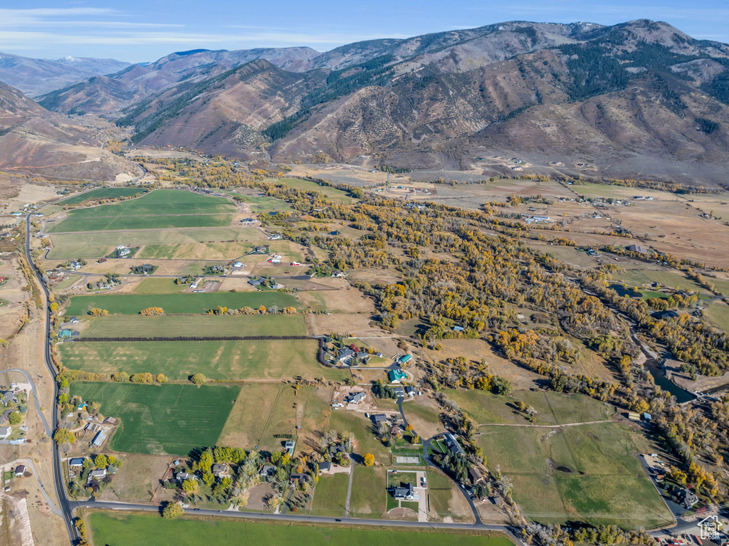 Aerial view of property\'s location featuring a mountainous background and rural landscape
