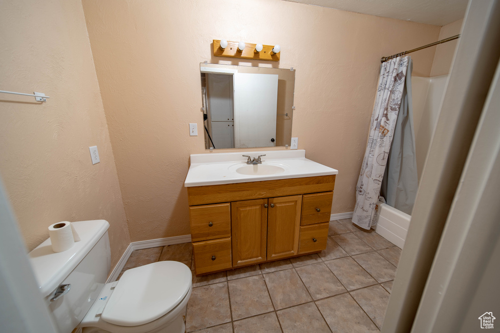 Full bathroom with vanity, tile patterned flooring, and shower / bathtub combination with curtain