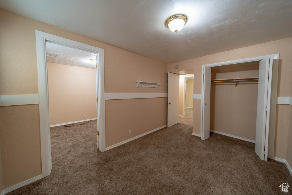 Unfurnished bedroom featuring carpet floors and a closet