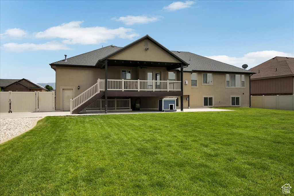 Rear view of property featuring a patio, stucco siding, a deck, and stairway