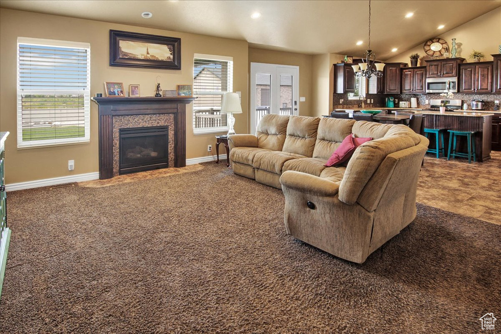 Living room with a chandelier, healthy amount of natural light, recessed lighting, a fireplace, and baseboards