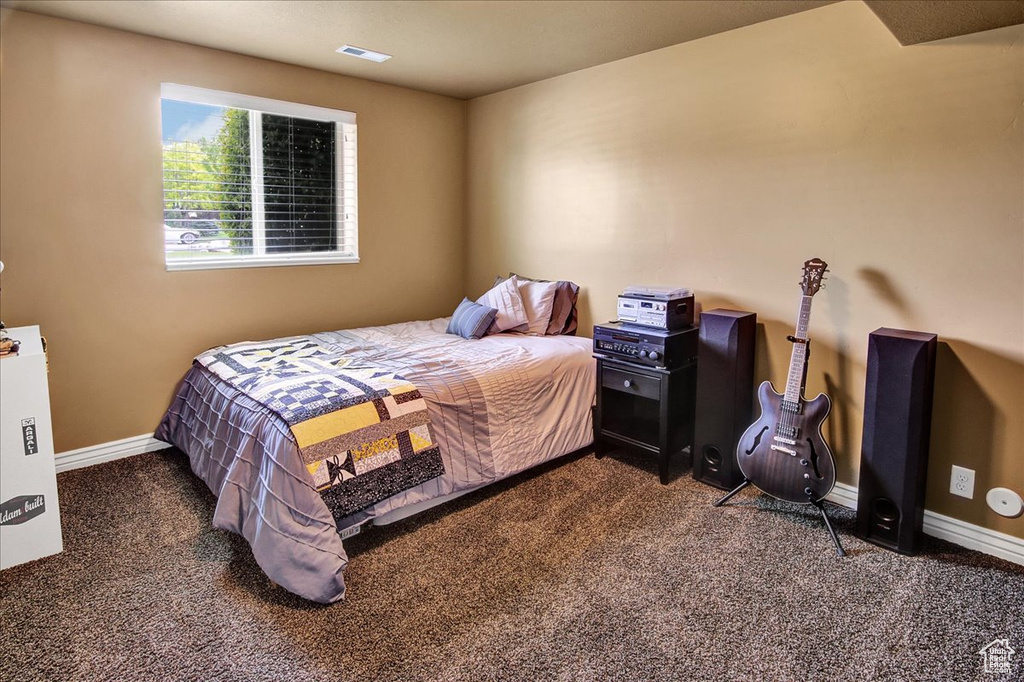 Carpeted bedroom with baseboards