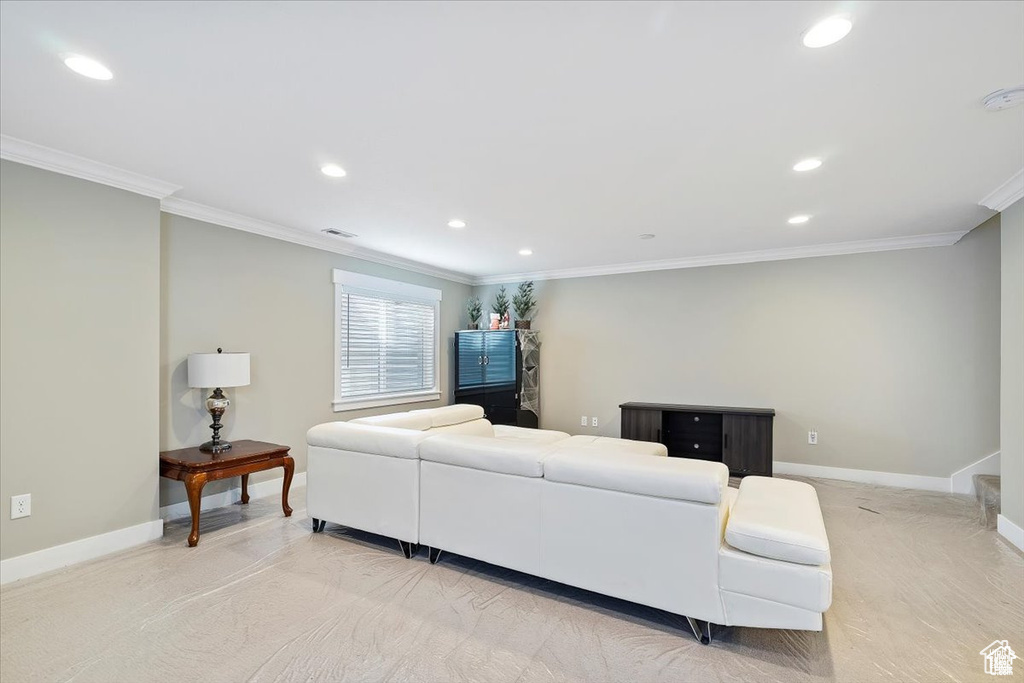 Living room featuring ornamental molding, baseboards, and recessed lighting