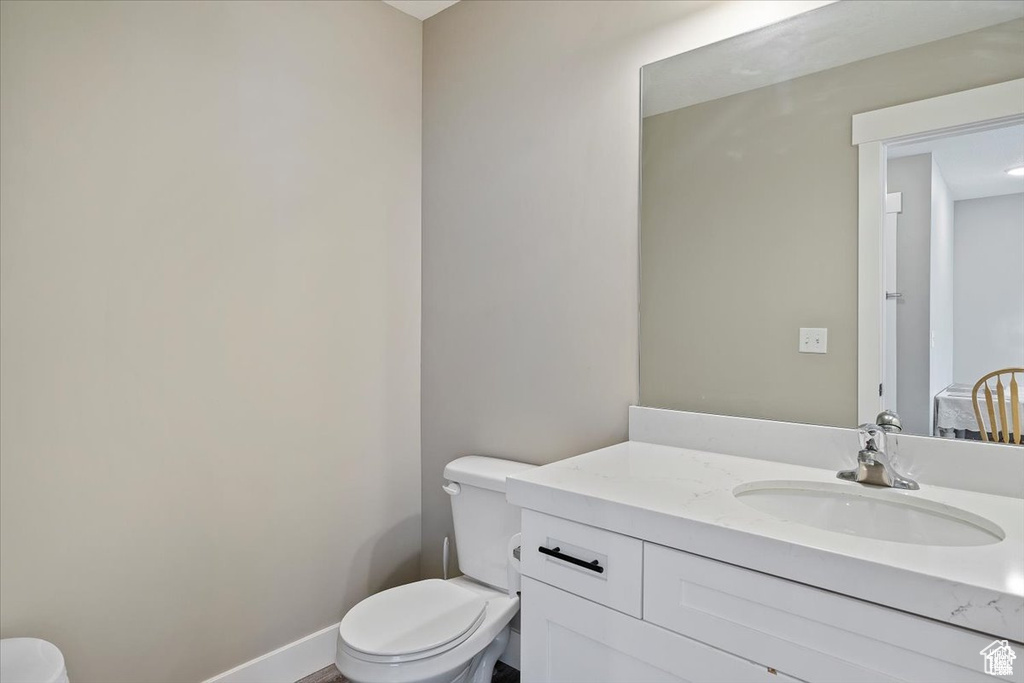 Half bathroom featuring toilet and vanity