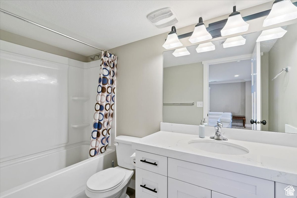 Full bath featuring shower / tub combo with curtain, vanity, and toilet