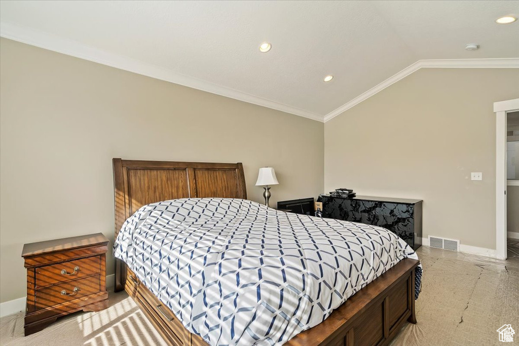 Bedroom featuring baseboards, lofted ceiling, recessed lighting, and crown molding