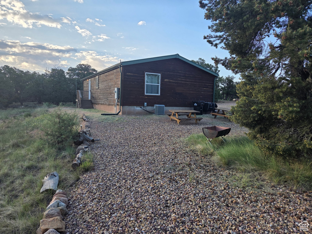 View of side of home featuring a central AC unit