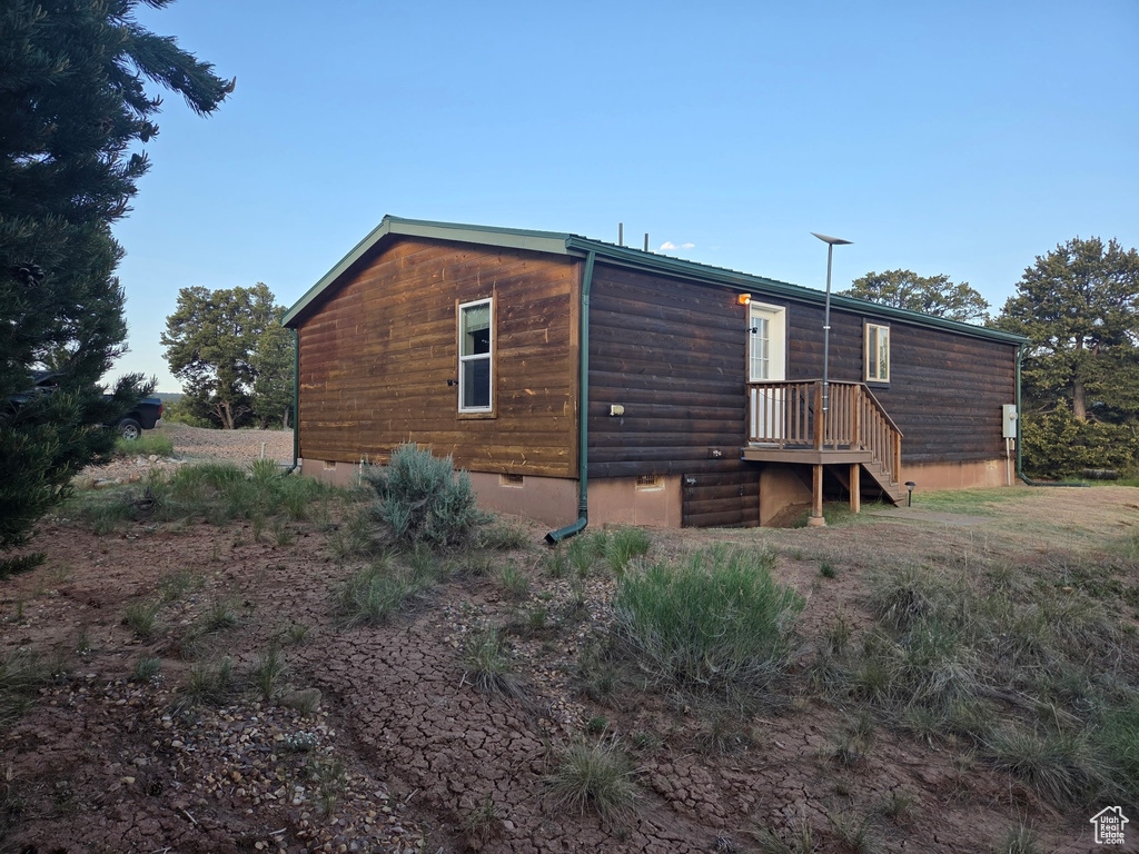 Back of house with crawl space