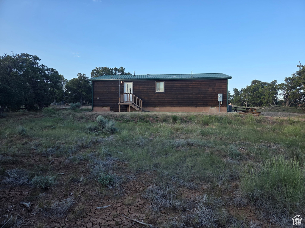 Rear view of property featuring a metal roof