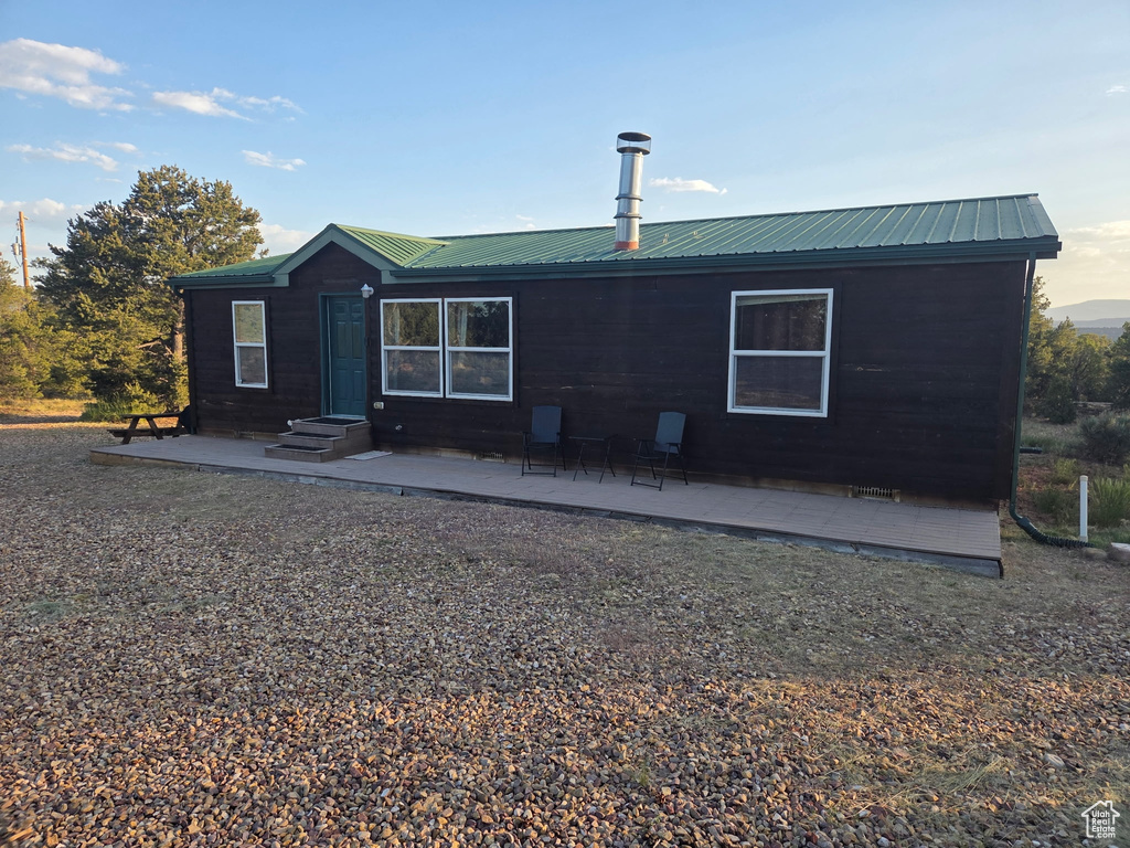Back of property featuring a metal roof