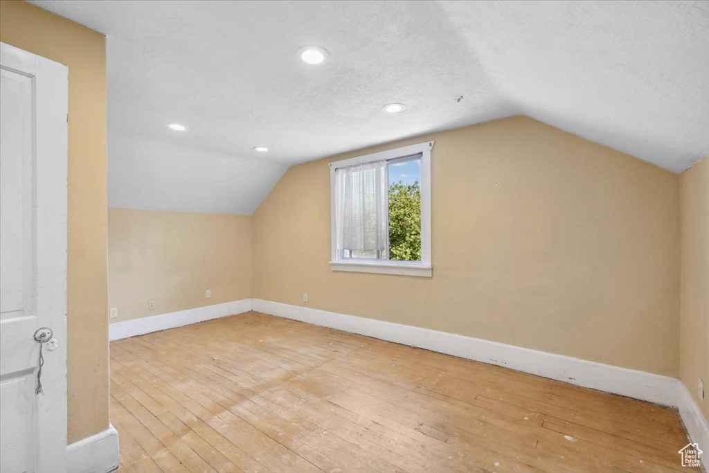Bonus room with wood-type flooring, vaulted ceiling, and recessed lighting
