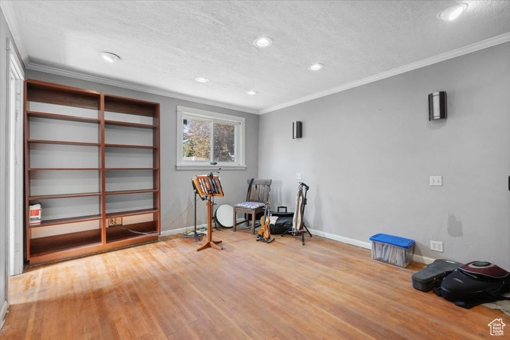 Unfurnished room with ornamental molding, wood finished floors, recessed lighting, and a textured ceiling