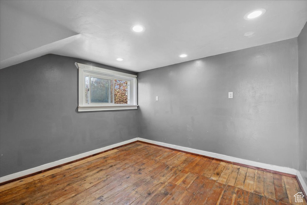 Bonus room with wood-type flooring, recessed lighting, and vaulted ceiling