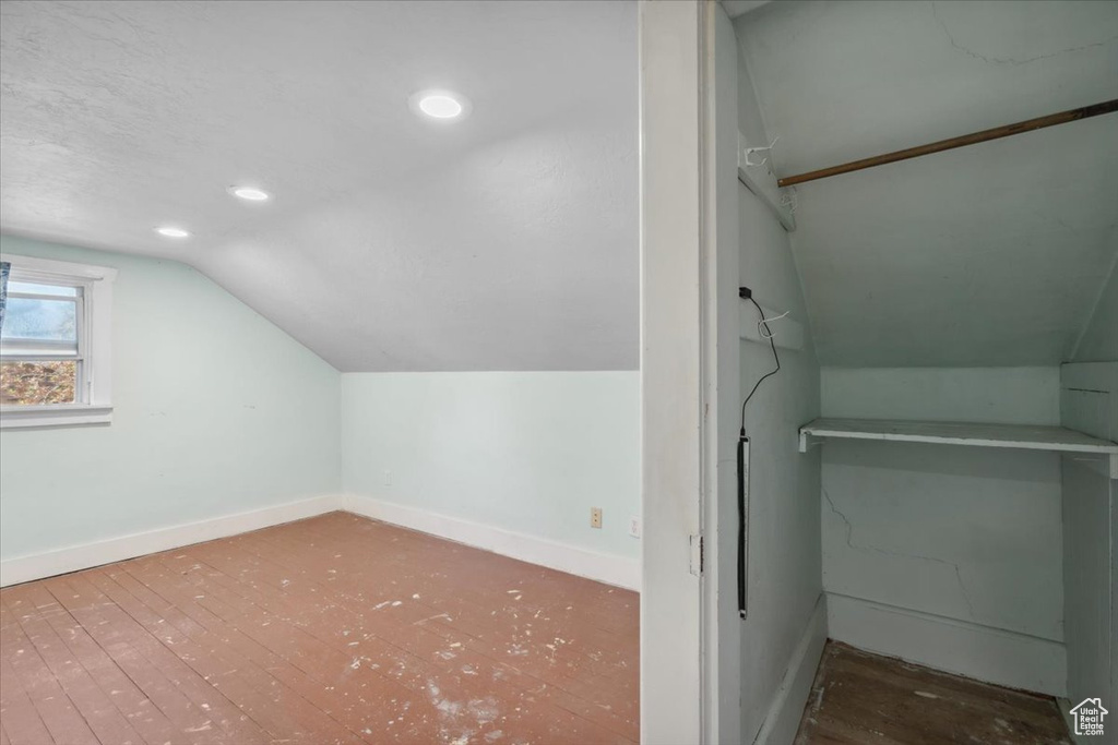 Additional living space with vaulted ceiling and recessed lighting
