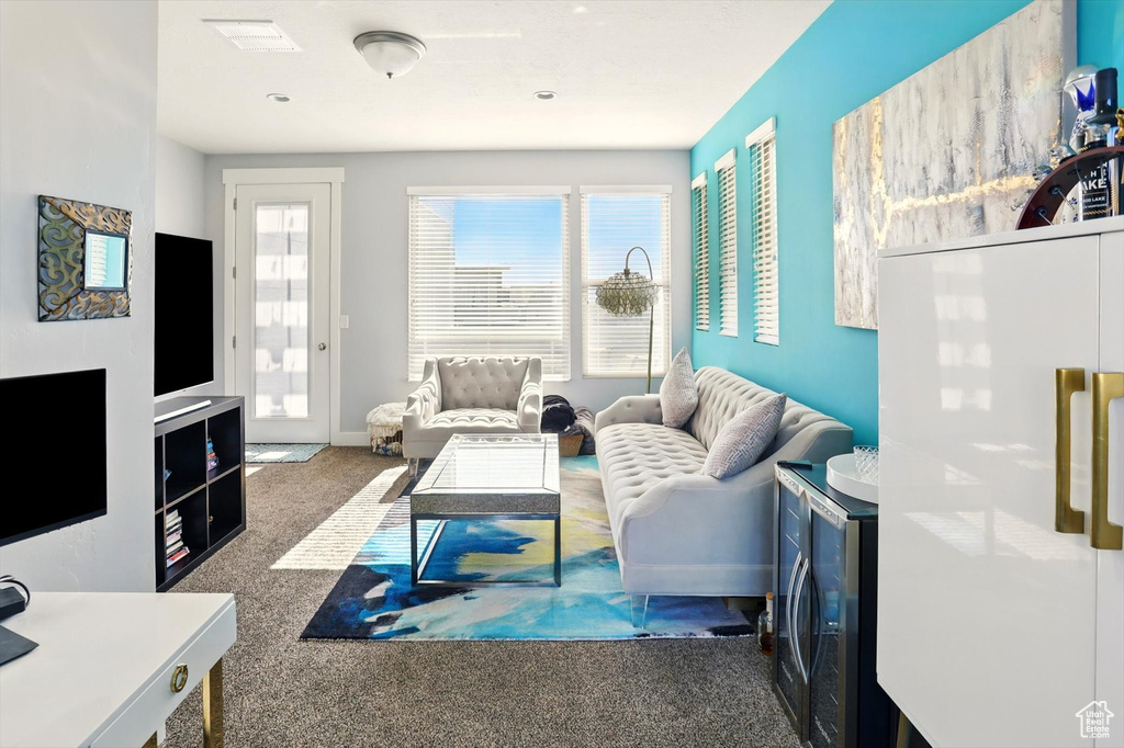 Living area featuring carpet floors and baseboards