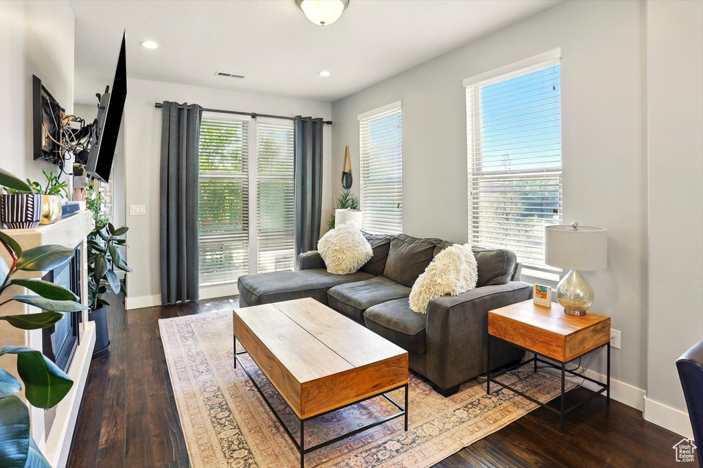 Living area with wood-type flooring, baseboards, and recessed lighting