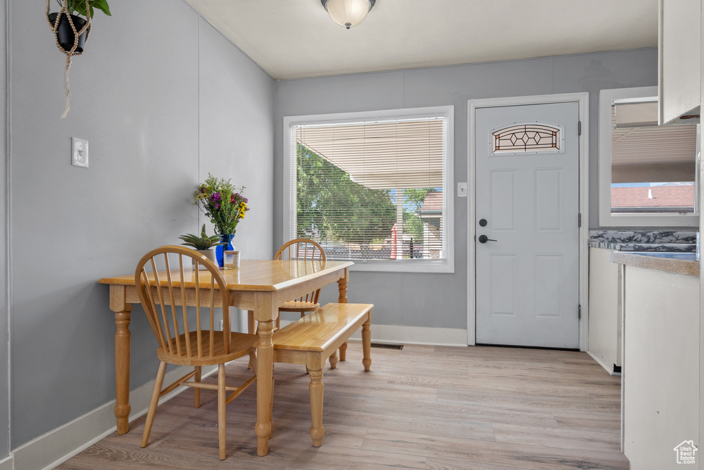 Dining room with light wood-type flooring and baseboards