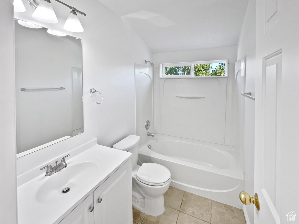 Full bath featuring tub / shower combination, vanity, and tile patterned floors
