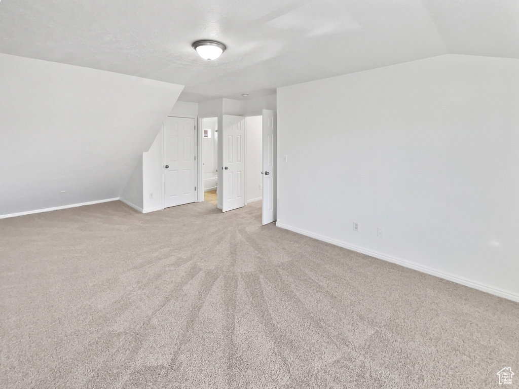Bonus room featuring carpet and lofted ceiling