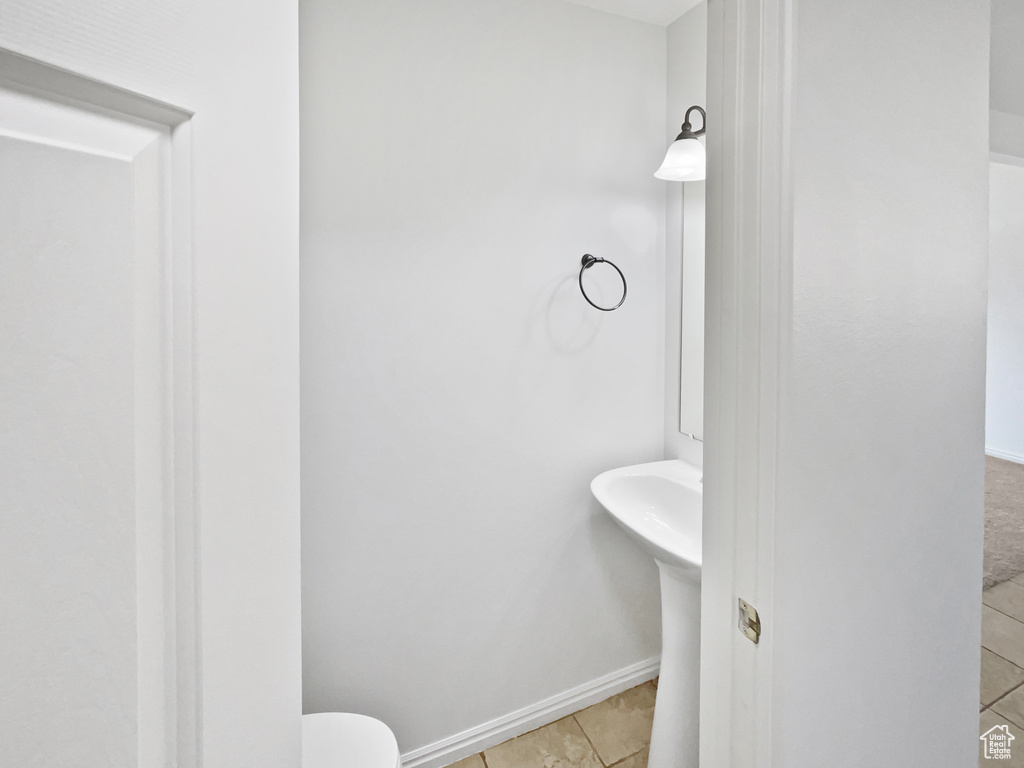 Bathroom with tile patterned flooring and baseboards