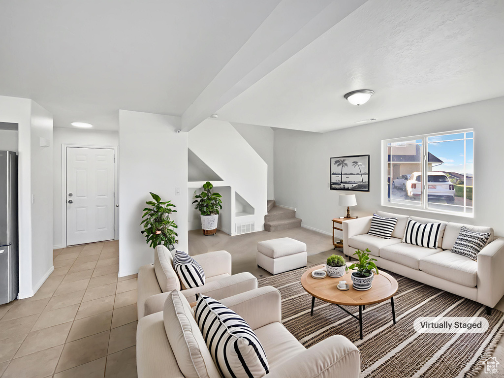 Living room featuring stairway and light tile patterned floors