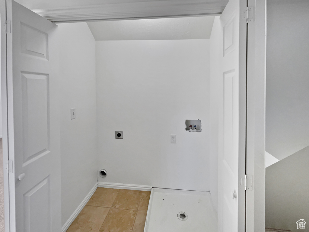 Washroom featuring washer hookup, hookup for an electric dryer, and light tile patterned floors