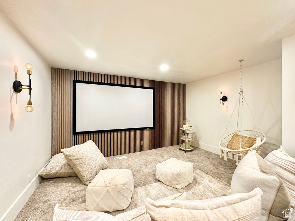 Home theater with carpet floors, recessed lighting, and an accent wall