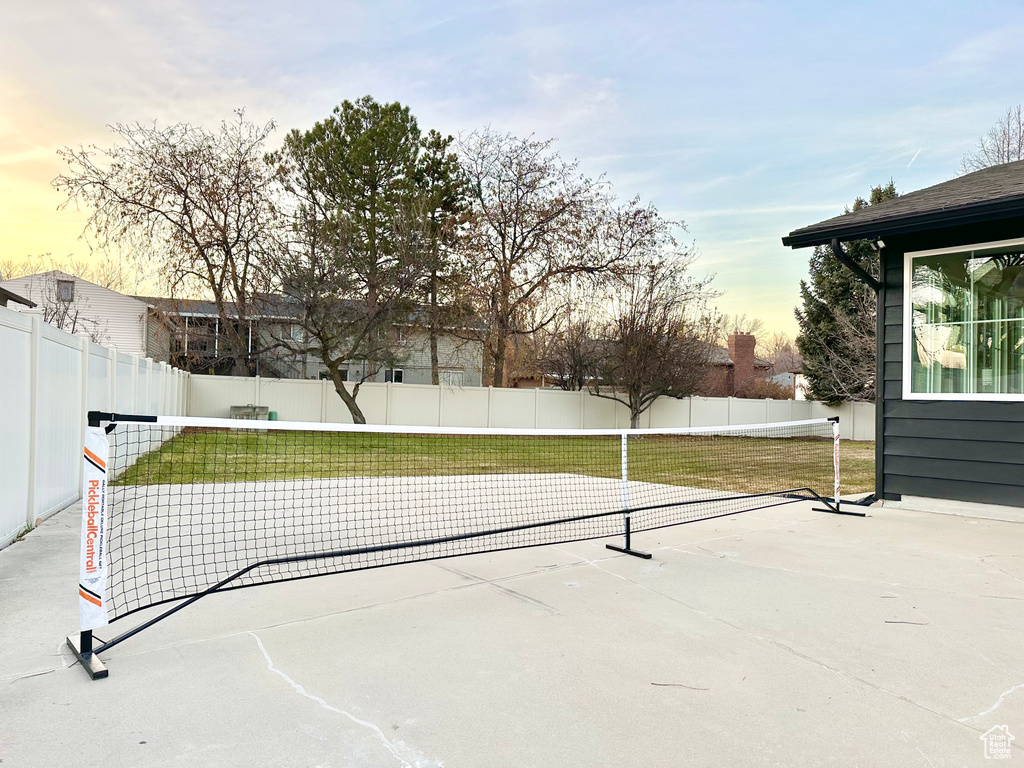 Patio terrace at dusk with a fenced backyard and a patio area