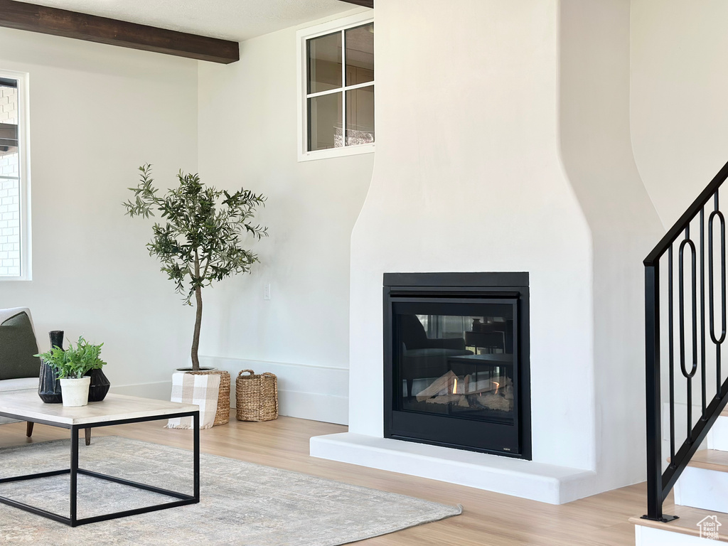 Detailed view of wood finished floors and a glass covered fireplace