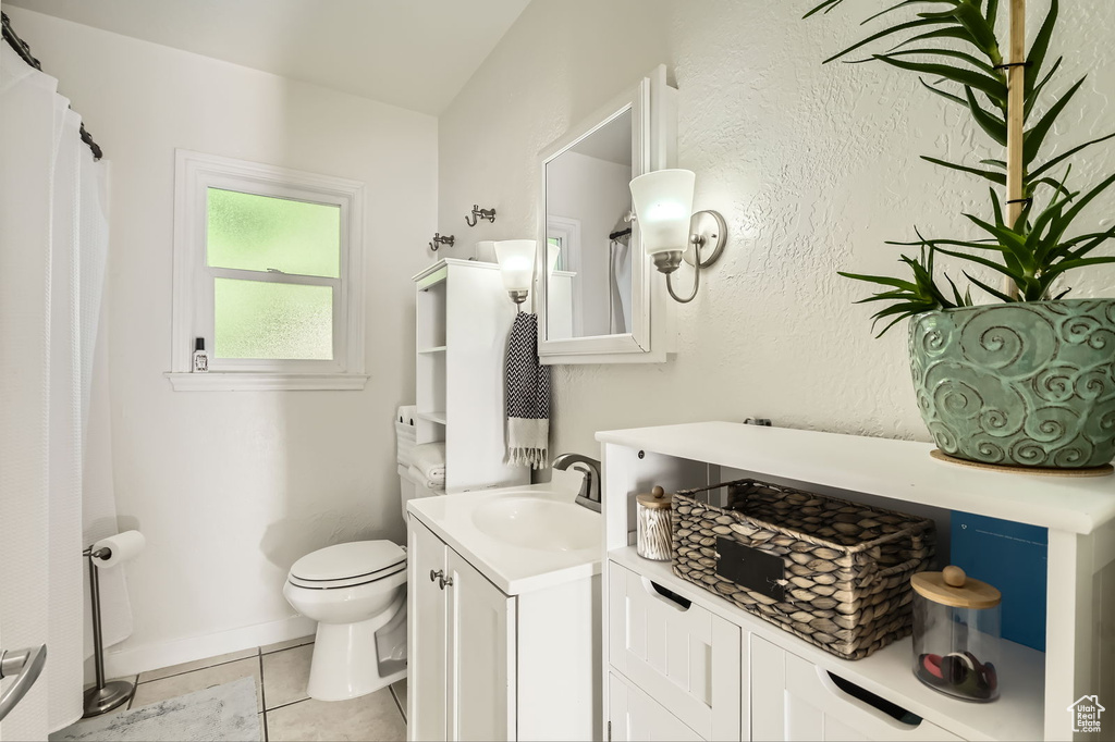 Bathroom with vanity, tile patterned flooring, and toilet