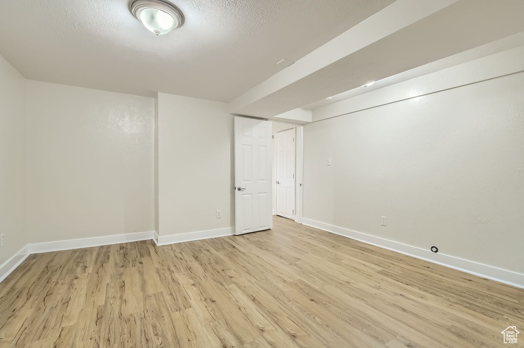 Finished basement featuring light wood-type flooring and baseboards