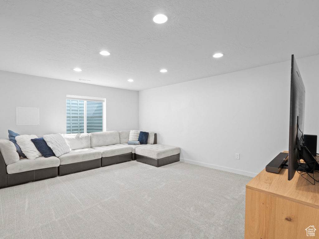 Carpeted living area with recessed lighting