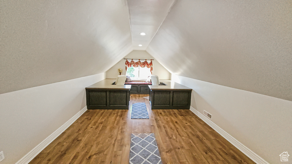 Unfurnished office featuring lofted ceiling, wood finished floors, and recessed lighting