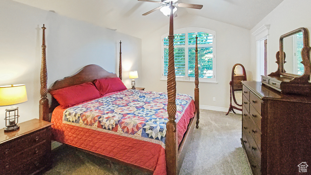 Bedroom featuring carpet floors, vaulted ceiling, and ceiling fan