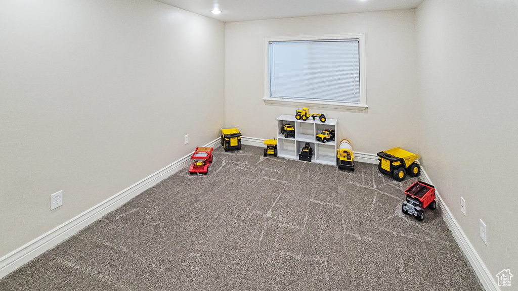 Recreation room with carpet flooring and recessed lighting