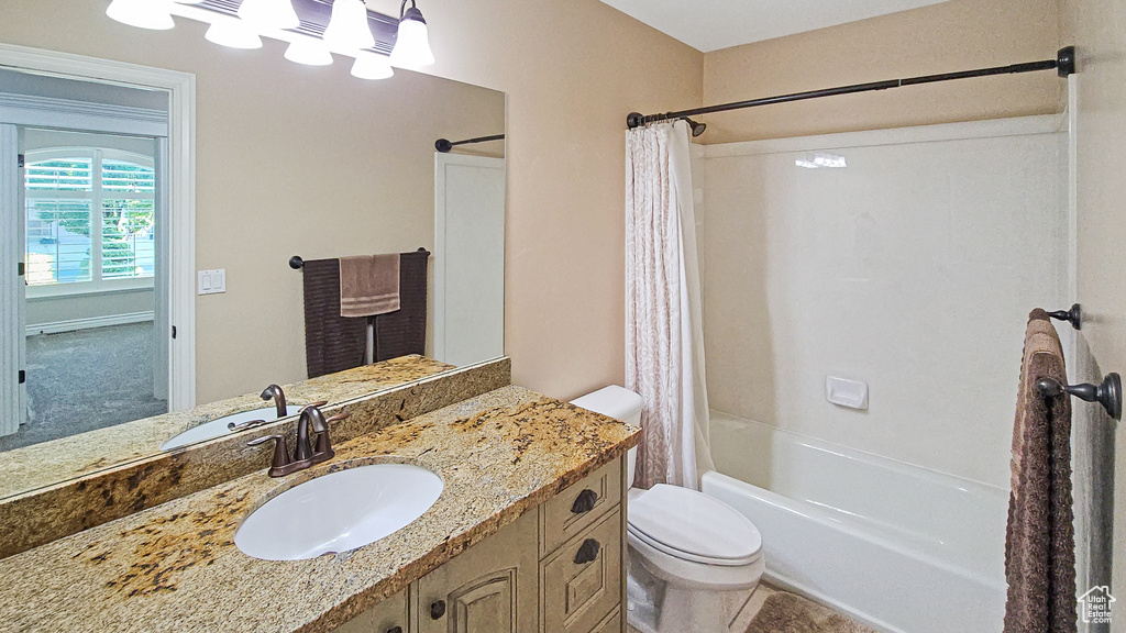 Full bath with shower / bath combo with shower curtain and vanity