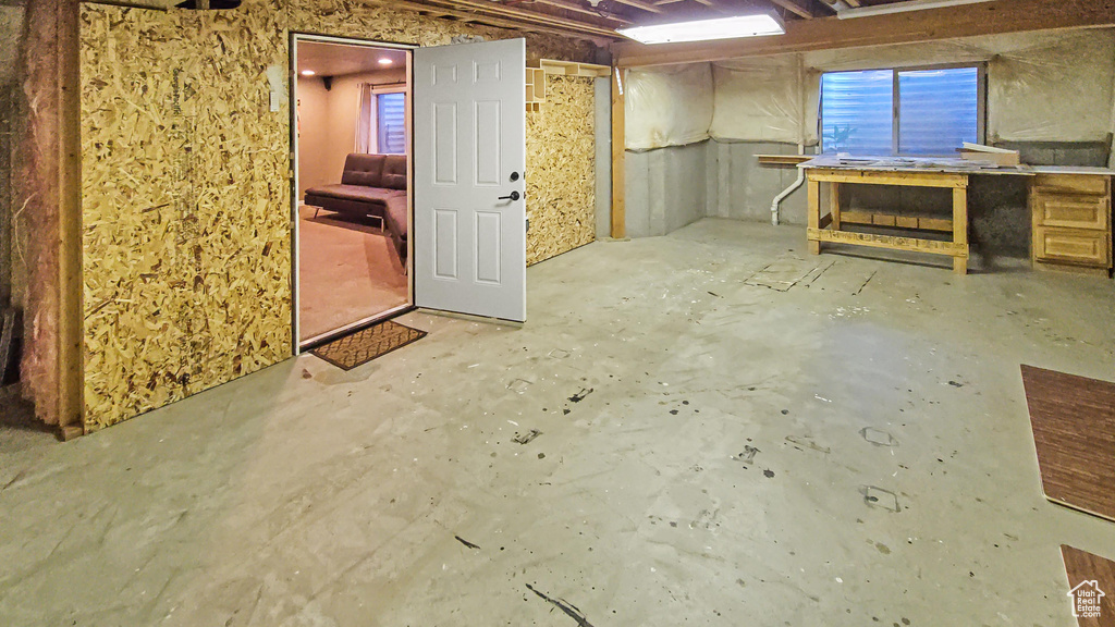 Unfinished basement with a workshop area
