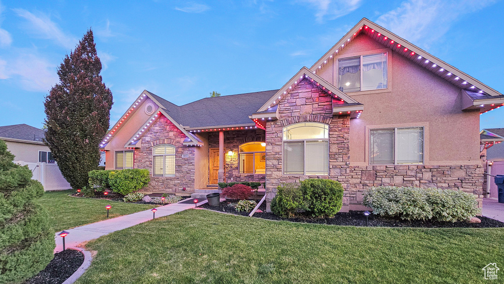 View of front facade featuring stone siding and stucco siding