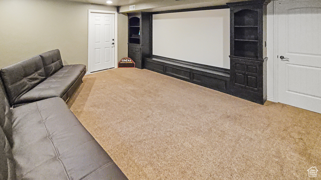 Carpeted home theater room with recessed lighting