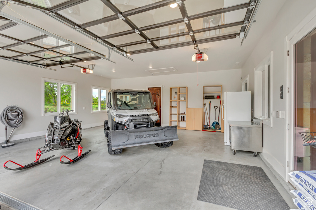 Garage with a garage door opener and baseboards