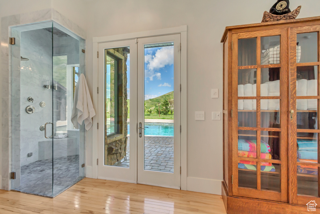 Doorway to outside featuring french doors, hardwood / wood-style floors, baseboards, and a mountain view