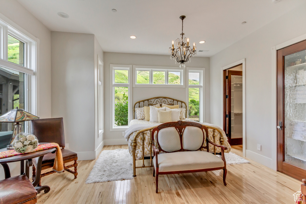 Bedroom with multiple windows, baseboards, a chandelier, and recessed lighting